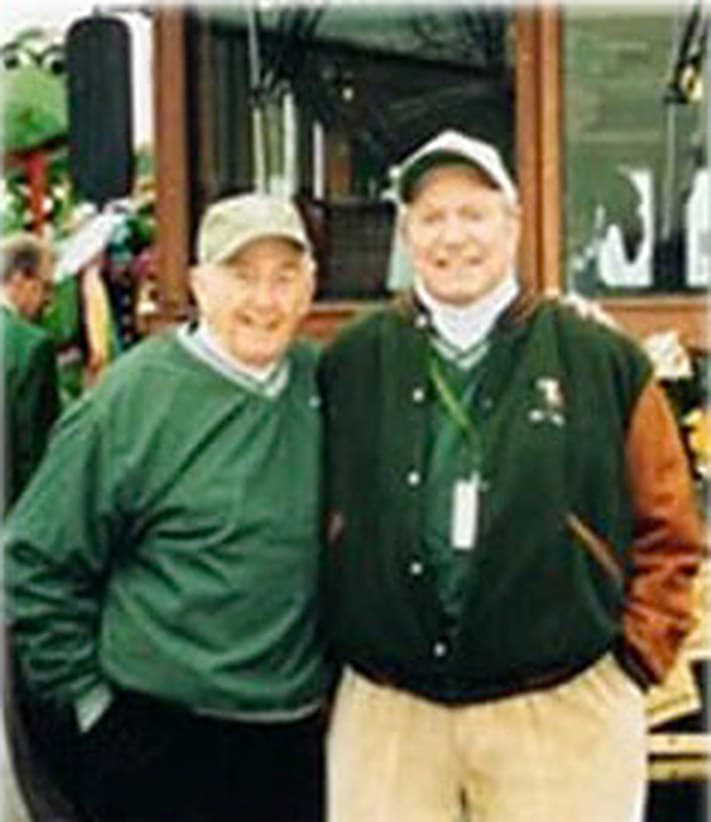 Bill Grigsby and Mickey Finn standing together in green jackets