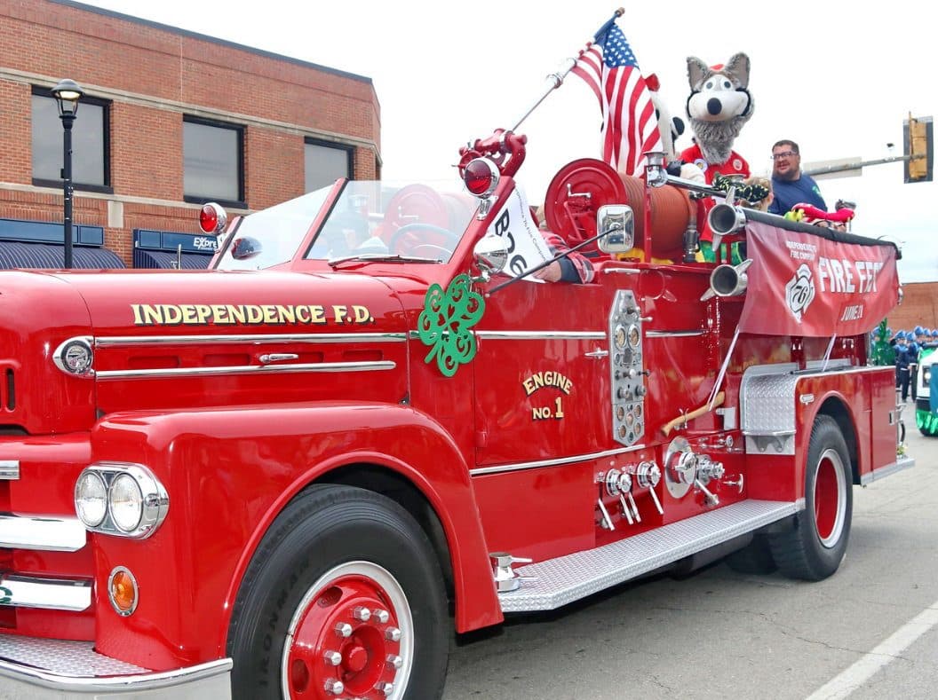 A vintage red Independence Fire Department engine decorated with shamrocks